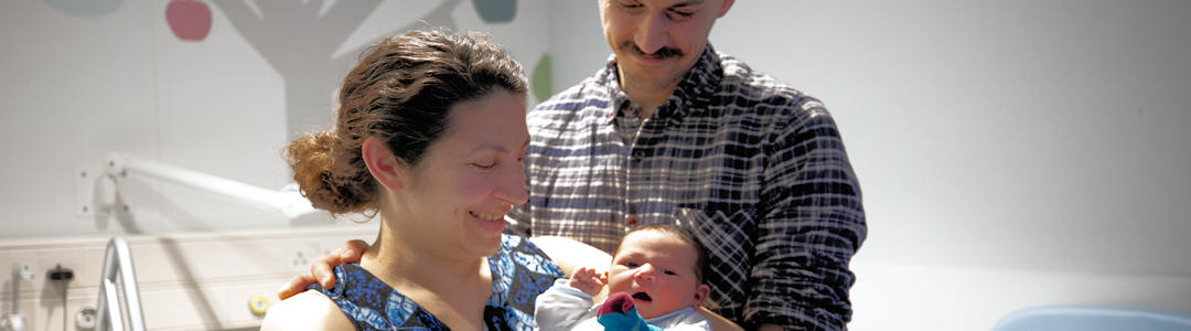 Mum holding baby with dad